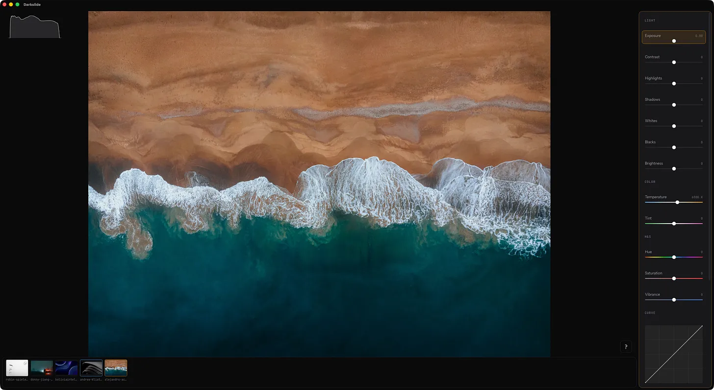 Beach shot → “bright sand and foam push the curve to the right”